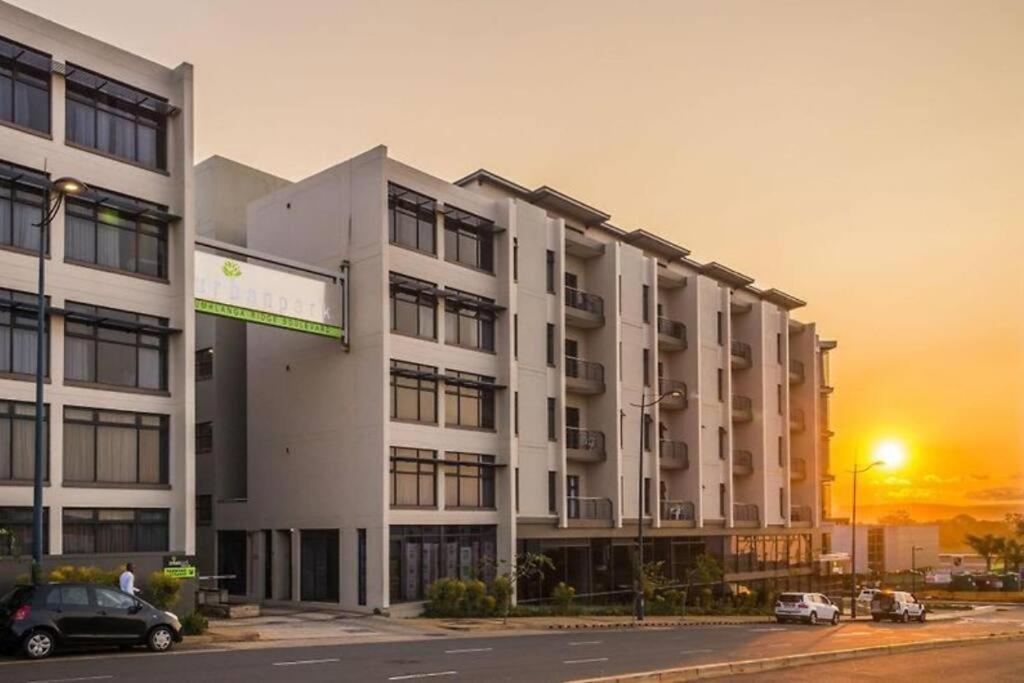 a large building with cars parked in front of it at Urban Studio Pvt Appartment in Durban