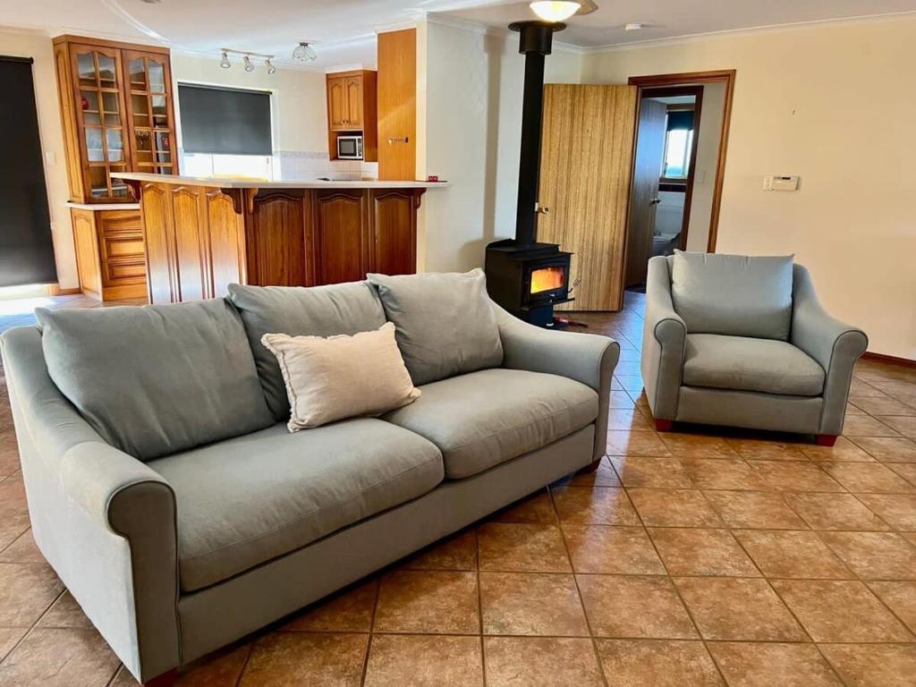 a couch and a chair in a living room at Sea Renity - Pet Friendly in Robe
