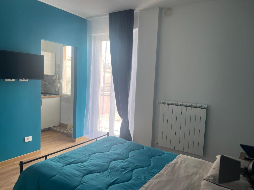 a bedroom with a bed and a large window at Casetta Tuscolana in Rome