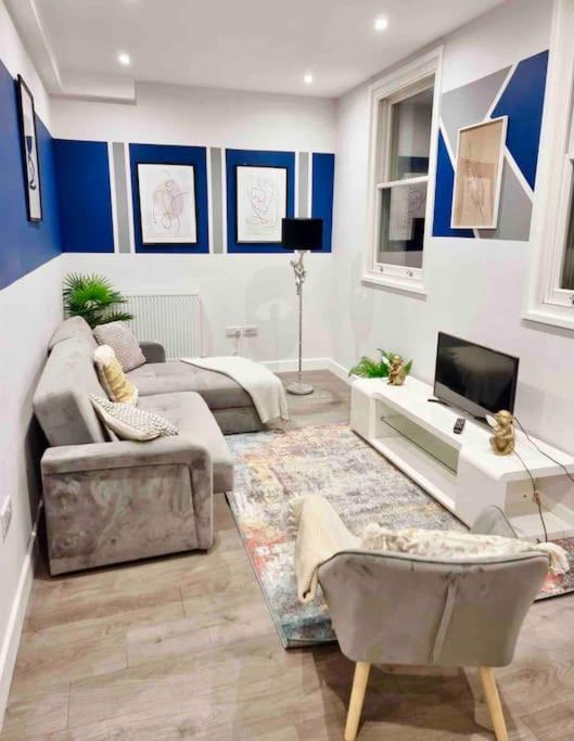a living room with blue and white walls at Coastal Luxury Home in Margate in Margate