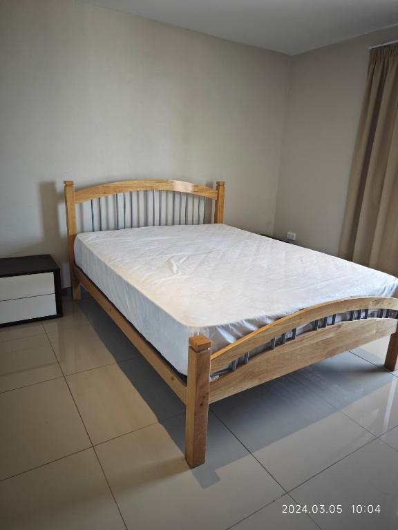 a bed in a room with a white mattress at 1 Pacific FairPrice in Nadi