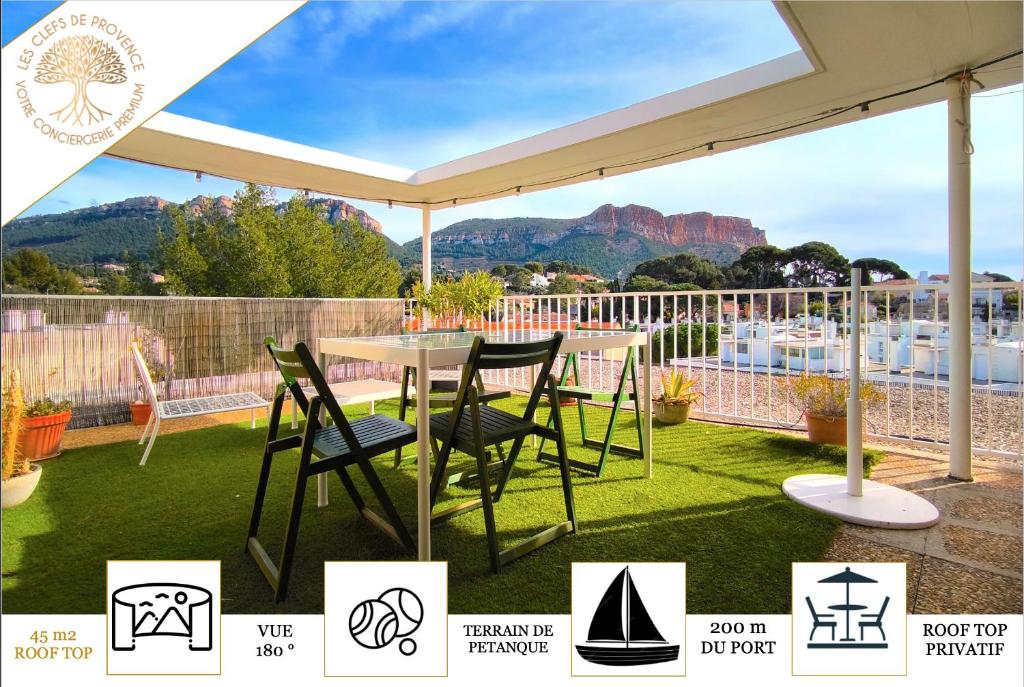 a patio with a table and chairs under a canopy at SUNSET GARDEN - Roof Top 45 m2 Vue Mer / Cap Canaille in Cassis