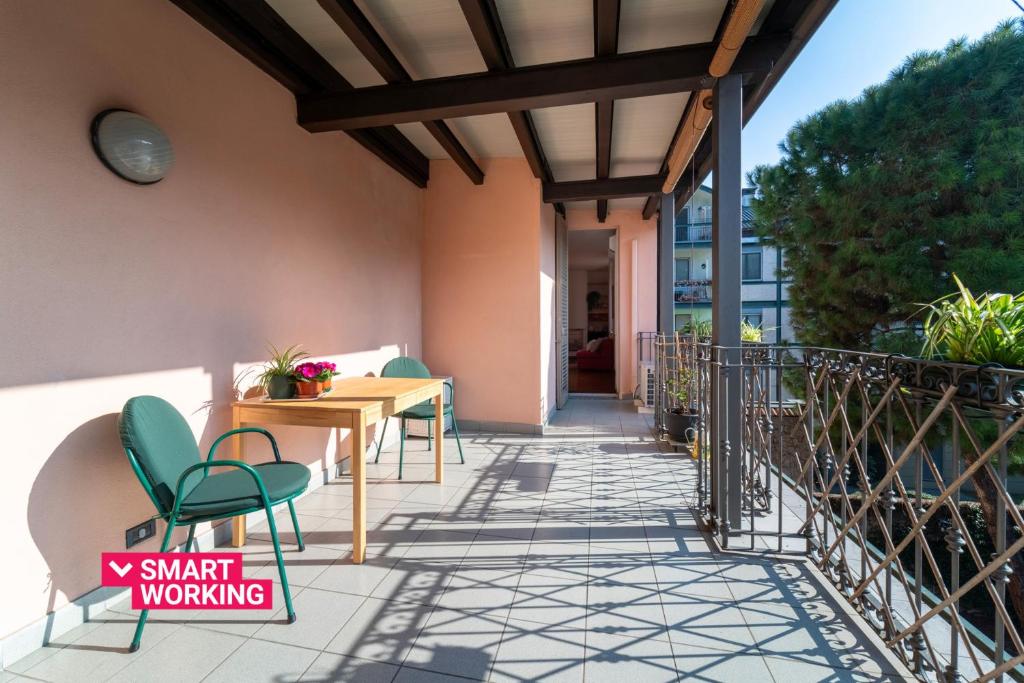 a patio with chairs and a table on a balcony at Gerbett Apartment with Terrace by Wonderful Italy in Como
