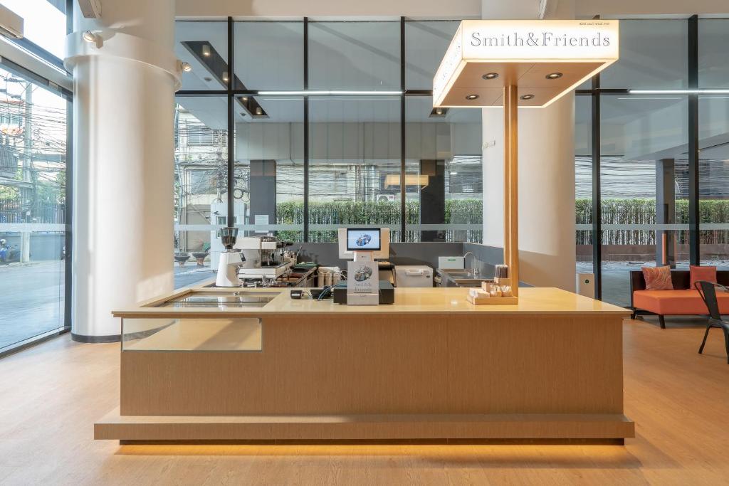 A hotel cafe-style counter in a bright glass-walled lobby.