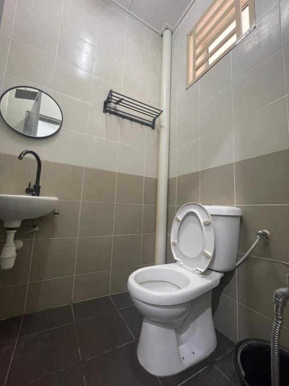 a bathroom with a toilet and a sink at BONDA ROSNAH HOMESTAY in Arau