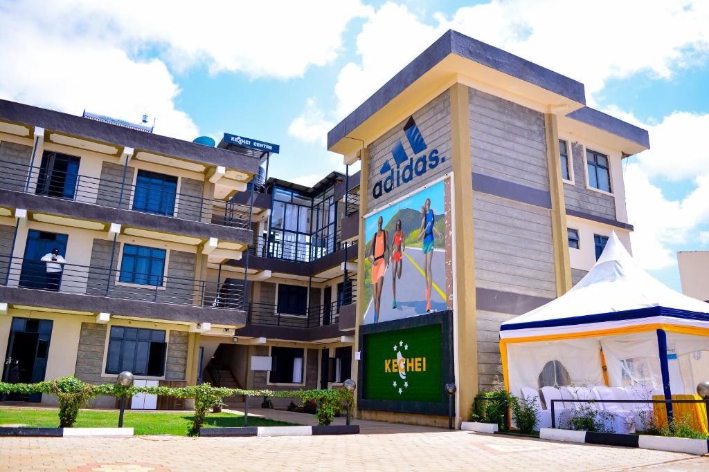 an apartment building with a sign in front of it at Kechei Centre in Iten