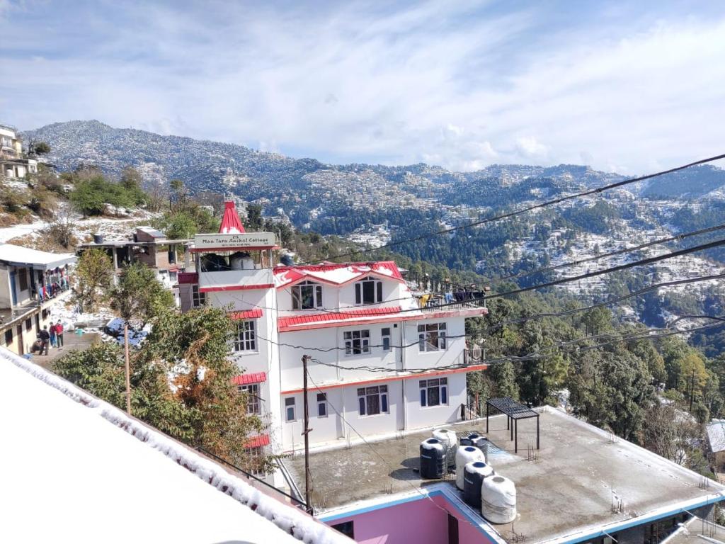 un gran edificio blanco con techo rojo en Maa Tara Anchal Cottage By BYOB Hotels, en Shimla