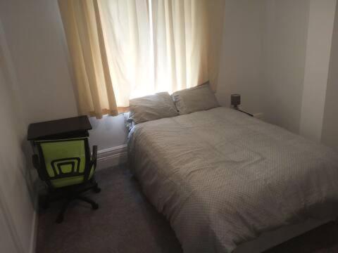 a small bedroom with a bed and a window at Double-bed (E1) close to Burnley city centre in Burnley