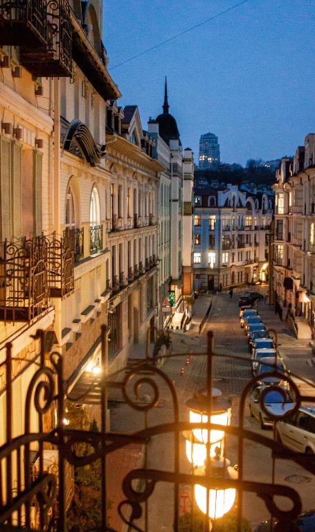 a city street with benches and buildings at night at Vozdvyzhensky Boutique Hotel in Kyiv