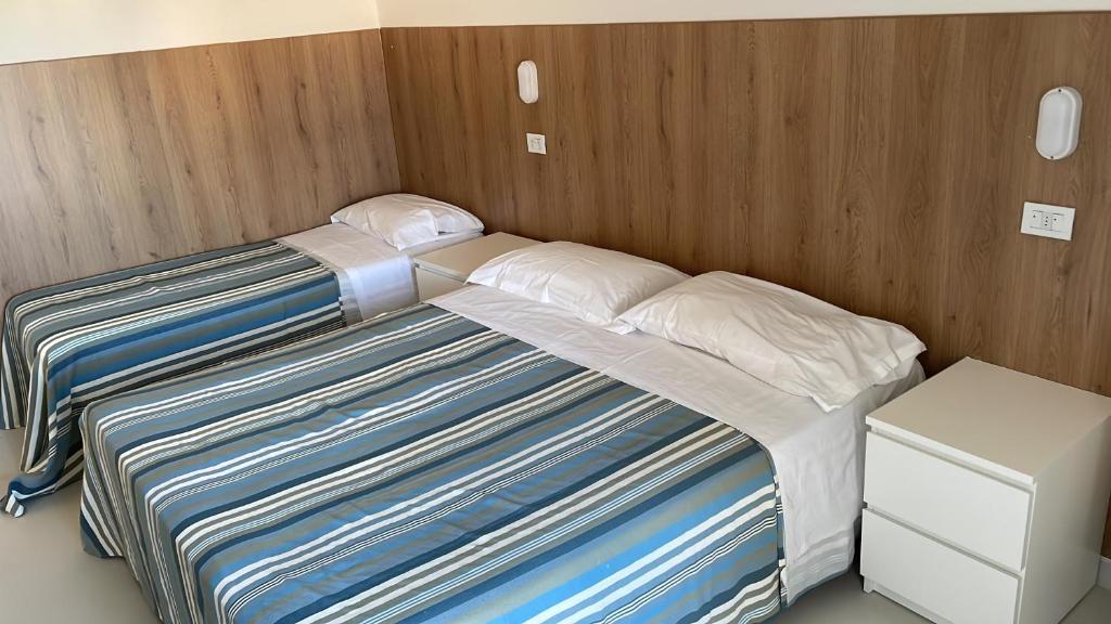Postel nebo postele na pokoji v ubytování Hotel Rosa