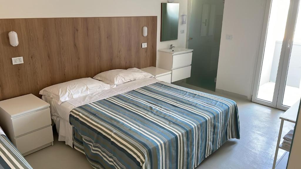 Postel nebo postele na pokoji v ubytování Hotel Rosa