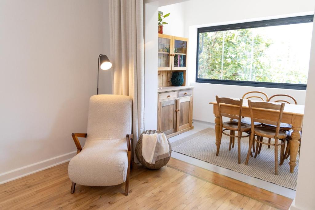 a dining room with a table and chairs and a window at Boho Chic Studio Stellenbosch in Stellenbosch