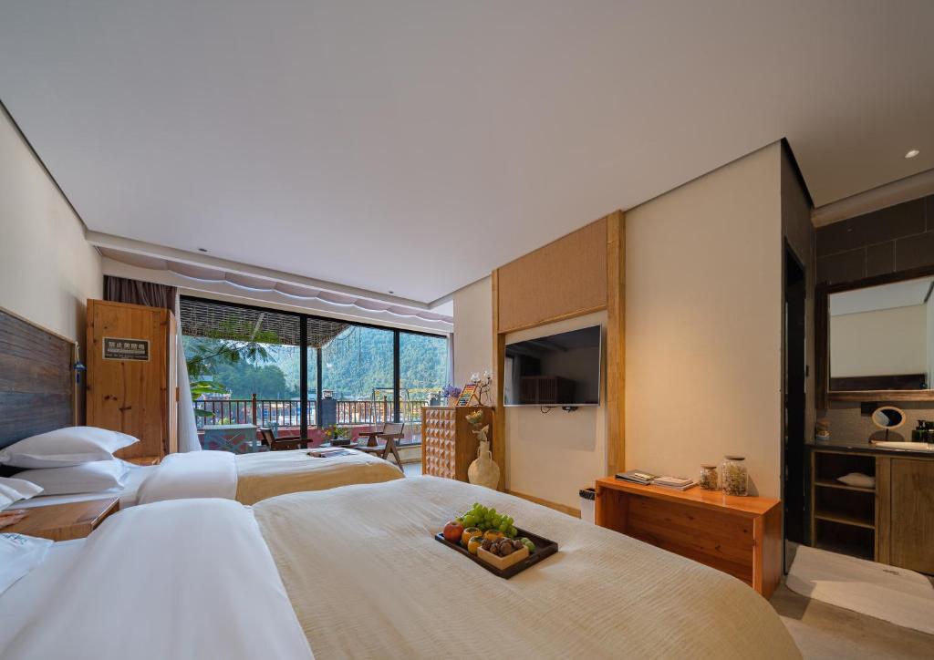 TV a/nebo společenská místnost v ubytování Wang Yun Residence Boutique Homestay Zhangjiajie