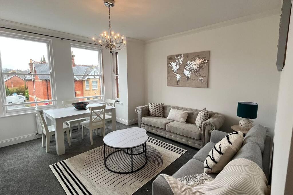 a living room with a couch and a table at NEW! Sleeps 4, Wimborne Centre, Parking & Wi-Fi - The Westborough Willows in Wimborne Minster