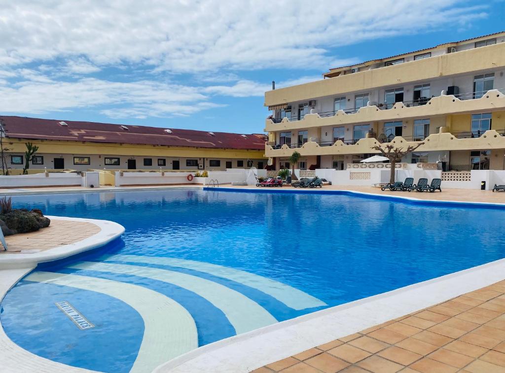 a large swimming pool in front of a hotel at Beach Paradise Apartment in Adeje