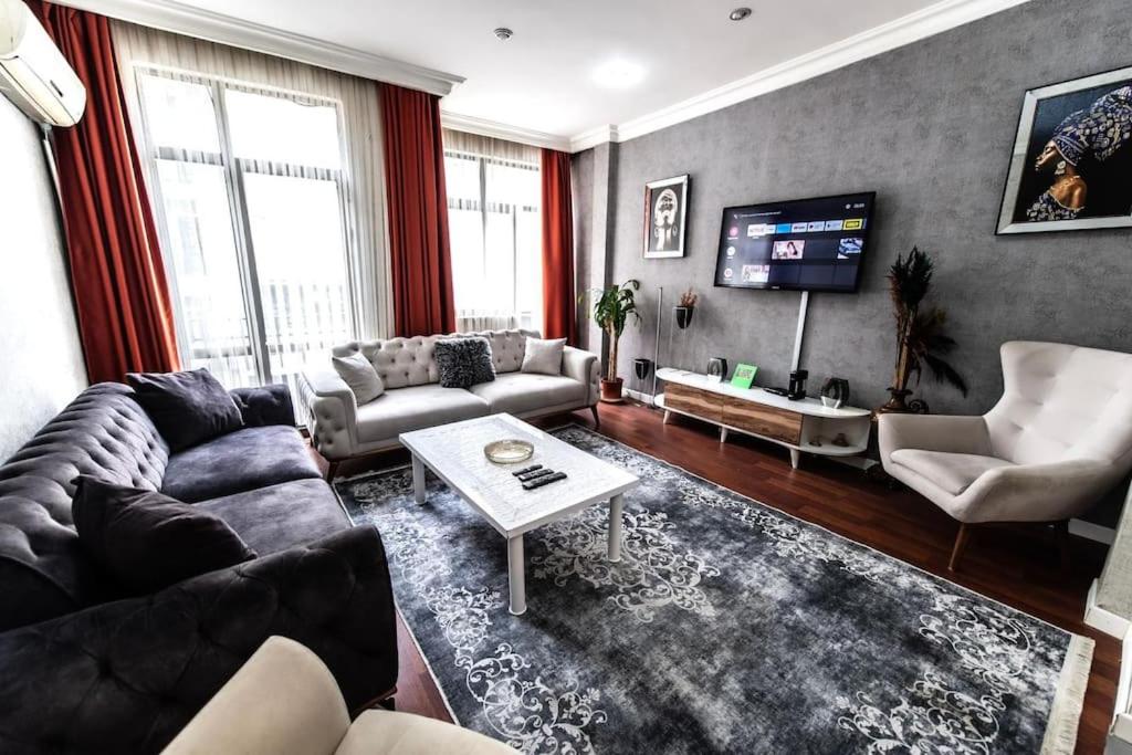 a living room with a couch and a tv at Best Location-Taksim Square Big and Modern Flat 140 (m2) 2+1 in Istanbul