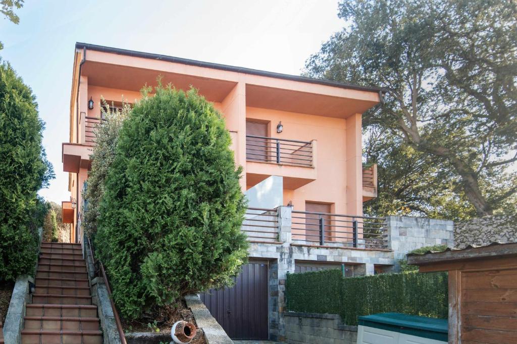 a house with a staircase in front of it at Vivienda Vacacional Eltxok in Llanes