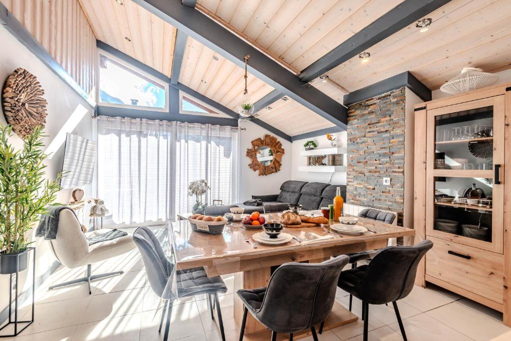 a kitchen and living room with a wooden table and chairs at SUPER MORZINE in Morzine