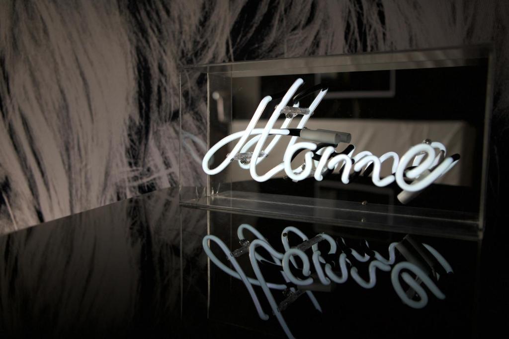 a neon sign that says elegance on a wall at @friends by CitySurfer in Hamburg