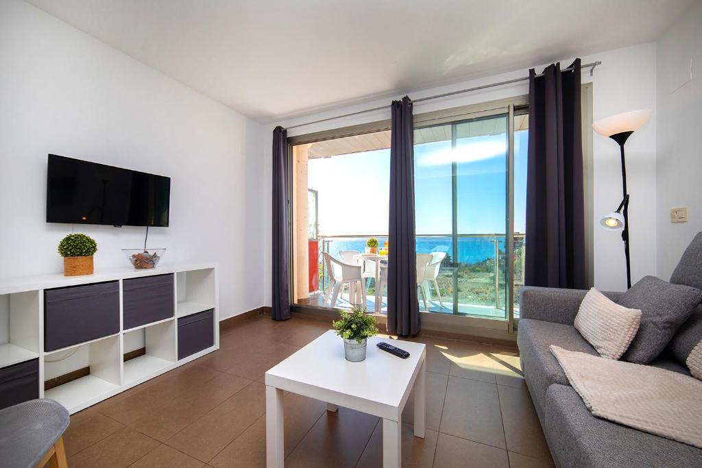a living room with a couch and a view of the ocean at Homeincalpe Borumbot in Calpe
