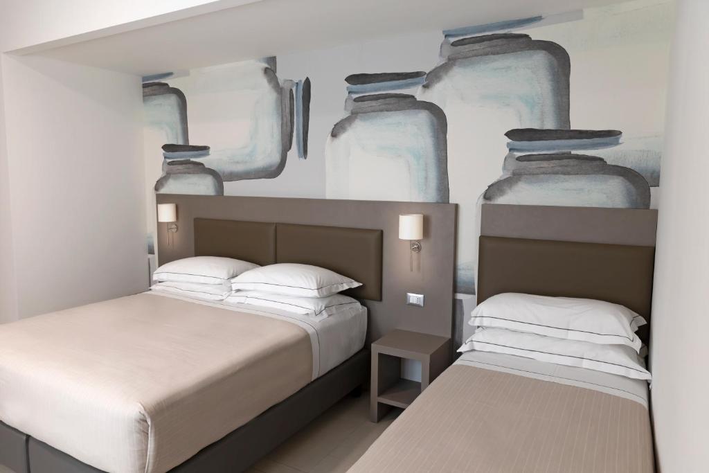 Postel nebo postele na pokoji v ubytování Hotel Miramare