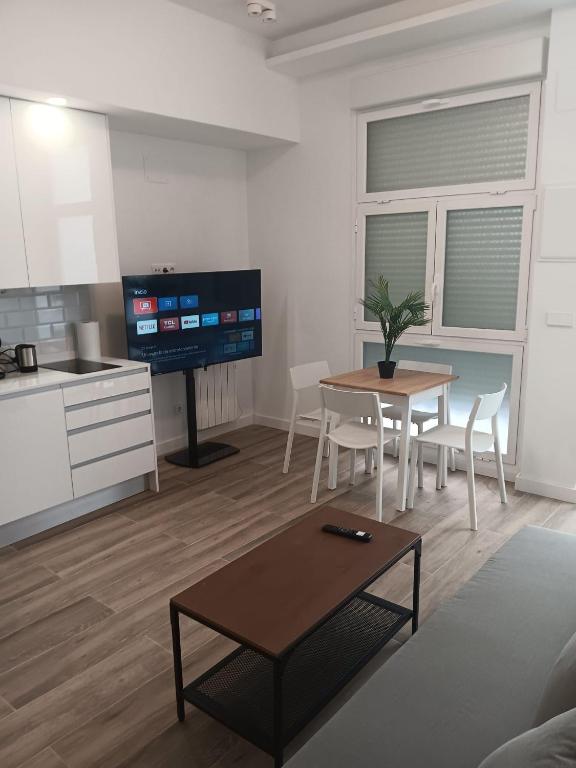 Il comprend un salon avec une table et une cuisine. dans l'établissement Plaza de Castilla2 Apartments2, à Madrid