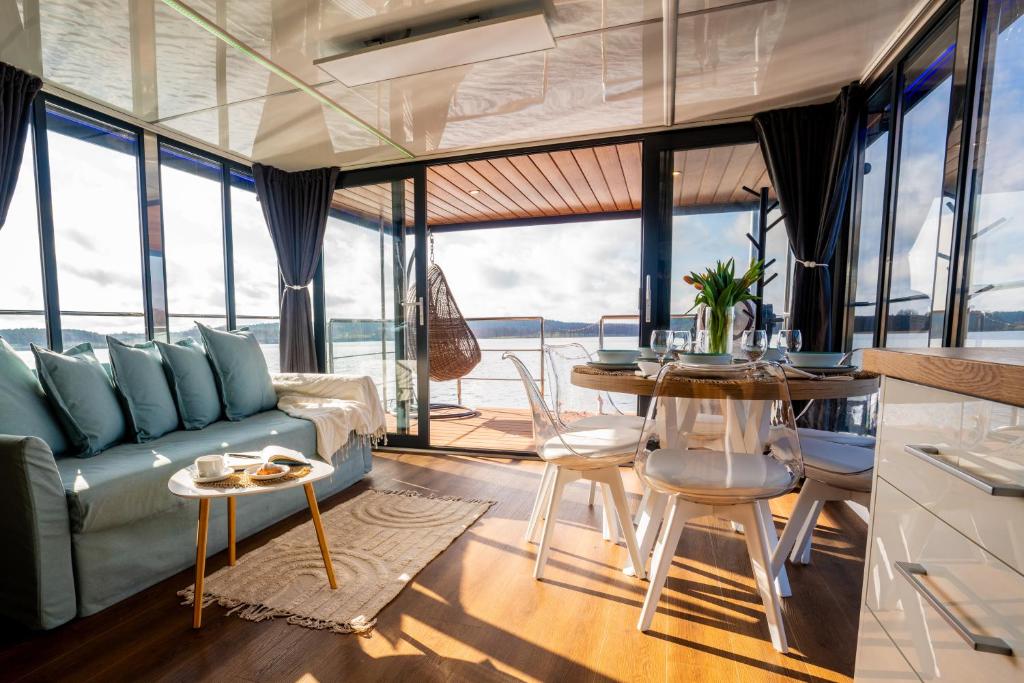 a living room with a couch and a table at Hotel Ukiel Wellness & SPA in Olsztyn