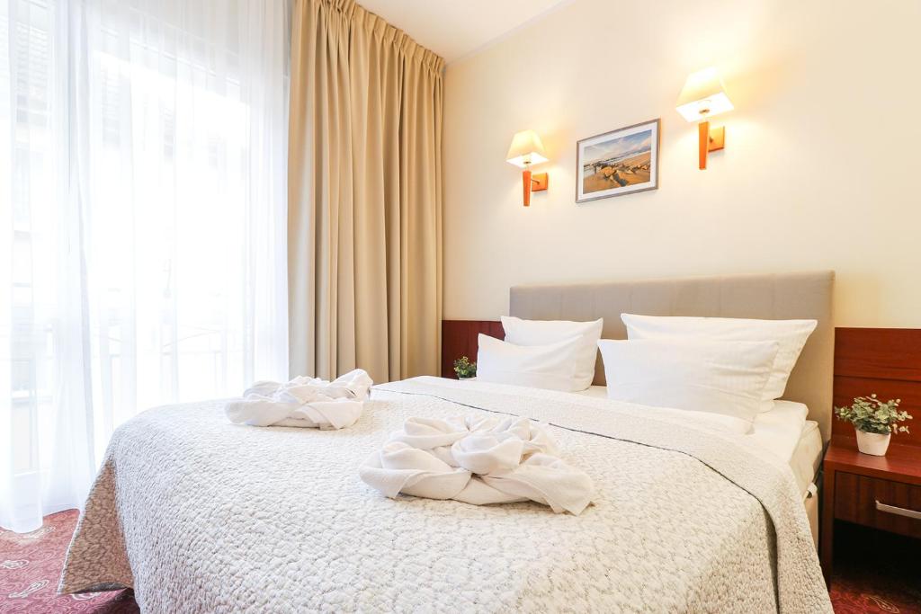 Postel nebo postele na pokoji v ubytování Atol Spa