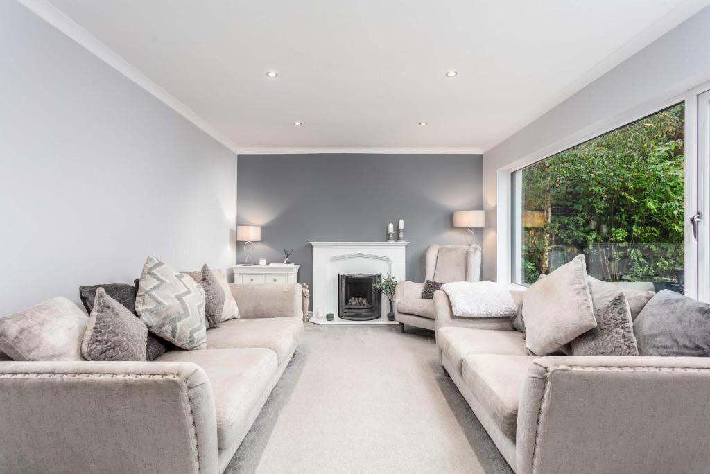 a living room with two couches and a fireplace at 46 Bathurst Drive in Ayr