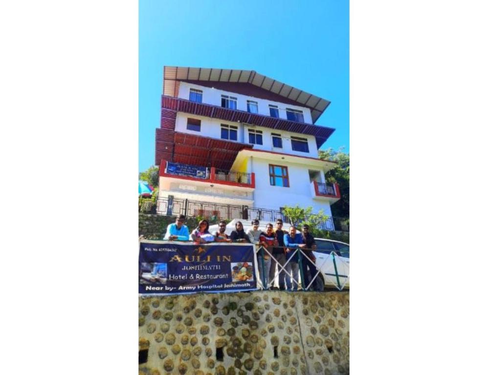 a group of people standing in front of a building at Hotel Auli Inn, Joshimath in Joshīmath