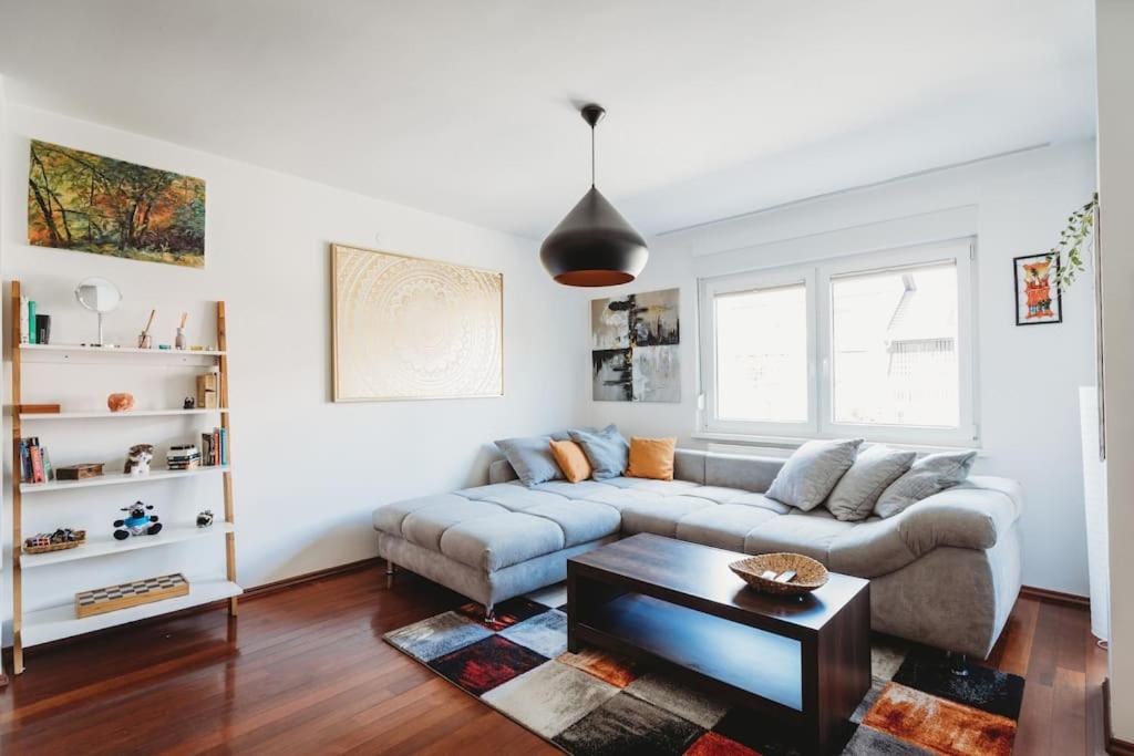 a living room with a couch and a table at Cozy Nest in quiet neighbourhood, free parking in Ljubljana