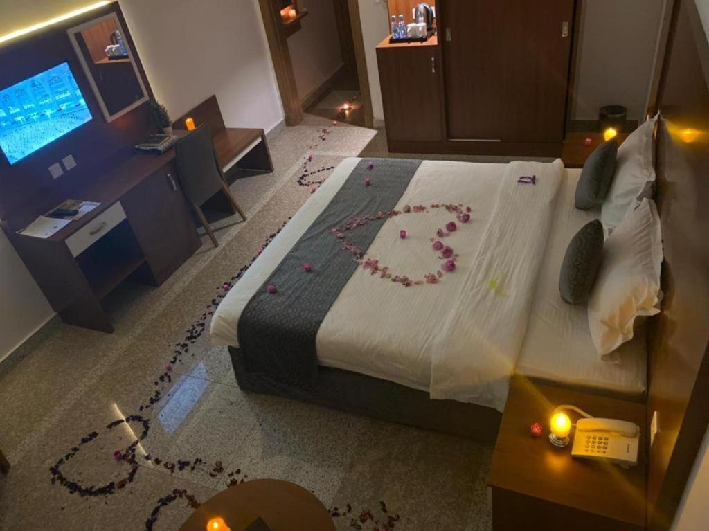 a bedroom with a bed with a peace sign on it at انوار احد in Al Madinah