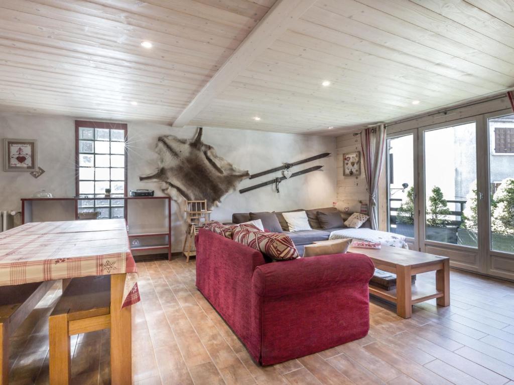 un salon avec un canapé rouge et une table dans l'établissement À la Clusaz : Appartement 3* avec Garage, Proche Pistes et Commerces - FR-1-304-93, à La Clusaz