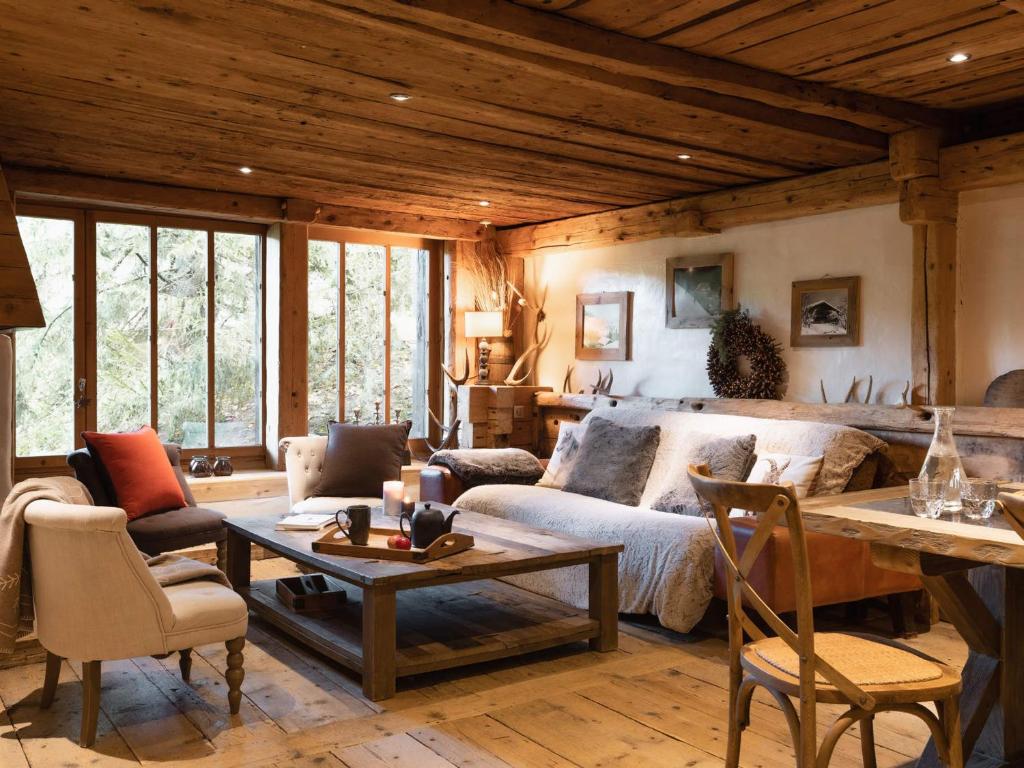 a living room with a couch and a table at Chalet La Clusaz, 6 pièces, 10 personnes - FR-1-304-162 in La Clusaz