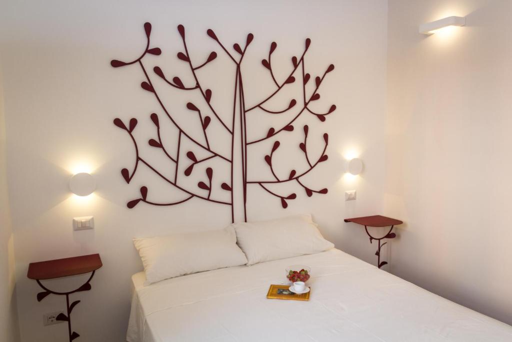 a bedroom with a tree on the wall at La Casa Di Iulia in Rome