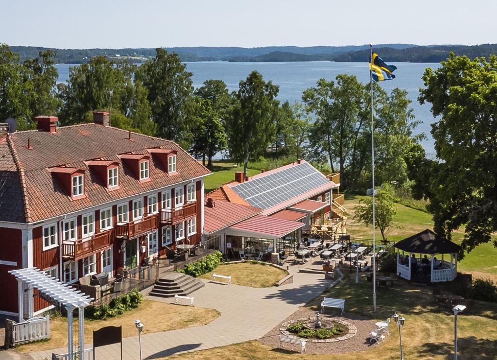 an aerial view of a building with a lake in the background at Smålandsgården in Gränna