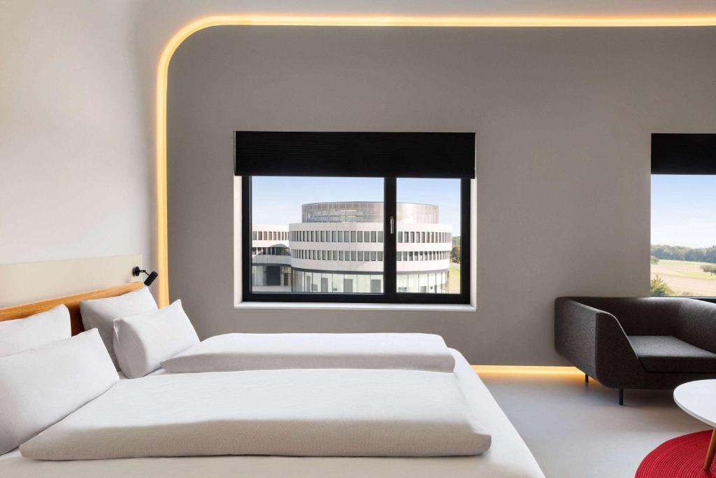 a hotel room with two beds and a window at Ernst Leitz Hotel Wetzlar direkt neben der Leica Welt in Wetzlar