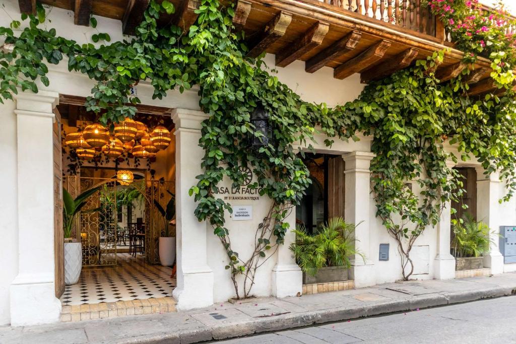 a building with ivy on the side of it at Hotel Casa La Factoria by Faranda Boutique, a member of Radisson Individuals in Cartagena de Indias