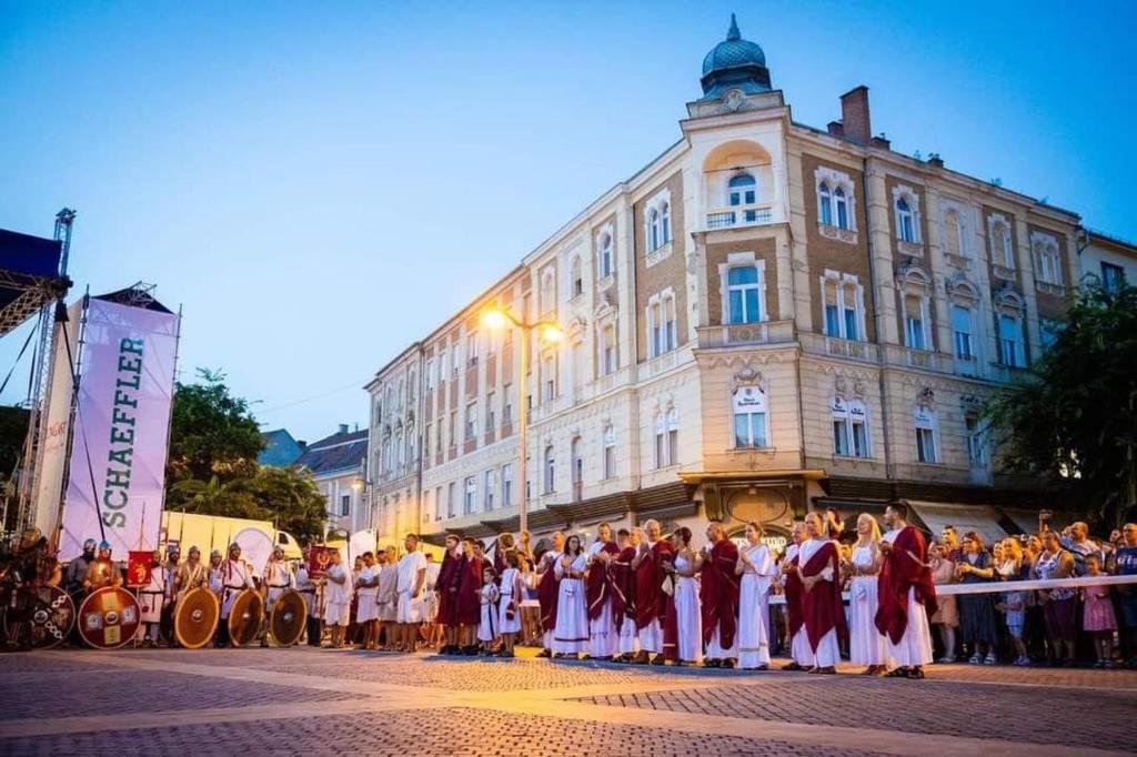 a group of people standing in front of a building at Vinci Apartman Szombathely in Szombathely