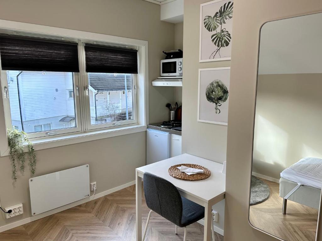 a small kitchen with a table and a window at Modern Central Apartment Apt 203 Studio in Stavanger