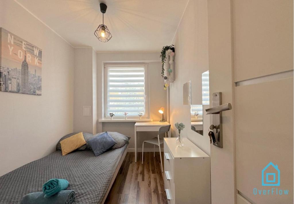 a small bedroom with a bed and a desk at Sensational room 10 Min to Old Town Gdańsk,PKP & Shopping Mall in Gdańsk