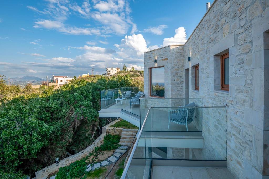 a house on a hill with a glass staircase at Maroulas Natura Palace in Giannoudi