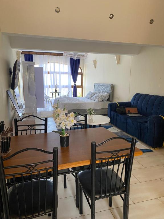 a living room with a table and chairs and a couch at Julia Ocean View Villa in Ukunda