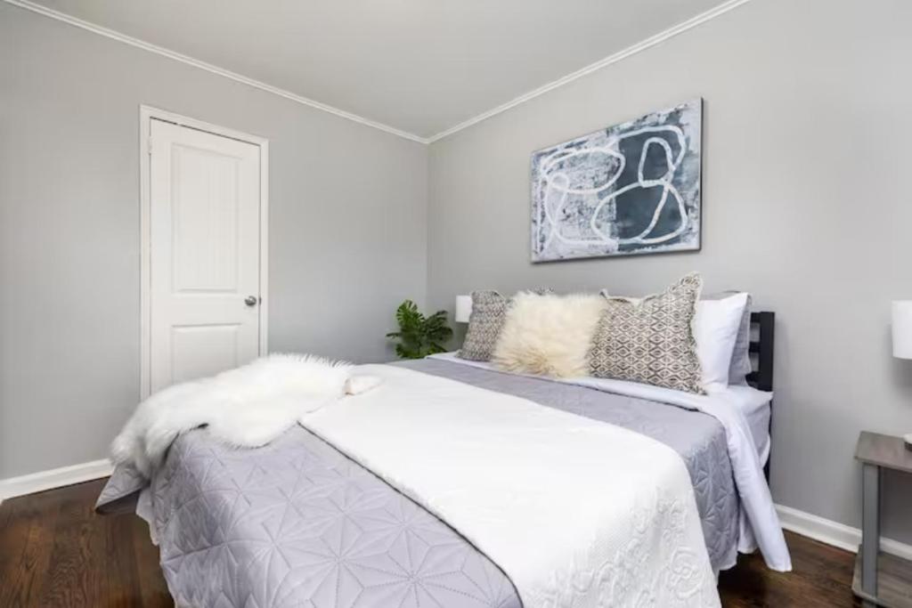 a bedroom with a bed with white sheets and pillows at King Bed Apt in West Hartford - Sleep 04 in Great Neighborhood in West Hartford