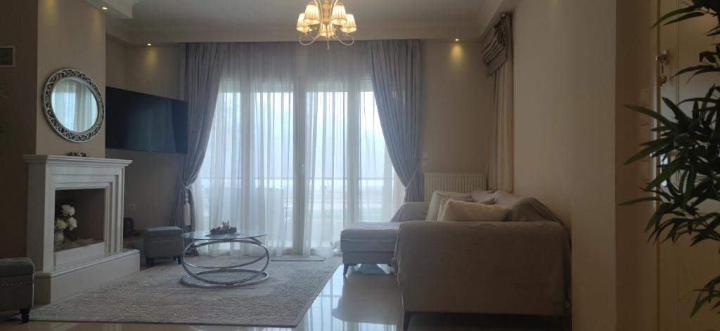 a living room with a couch and a large window at Η πέρλα της λίμνης/ The lake's pearl in Ioannina