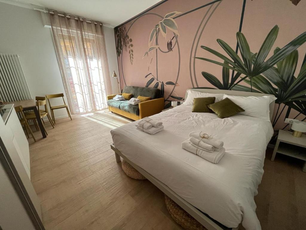 a bedroom with a large bed with two towels on it at Calari Rooms - Monolocale in Bologna