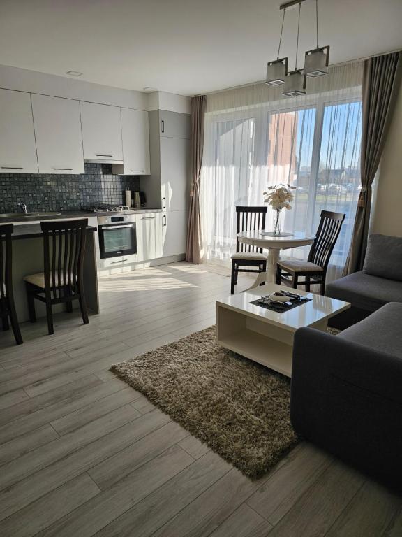 a living room with a couch and a table at Family apartment in Kretinga