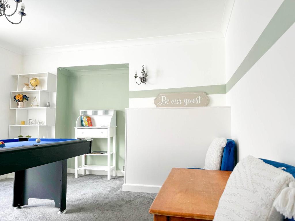 a playroom with a pool table and a book shelf at Zen 8-Bedroom Den in Edgbaston in Birmingham