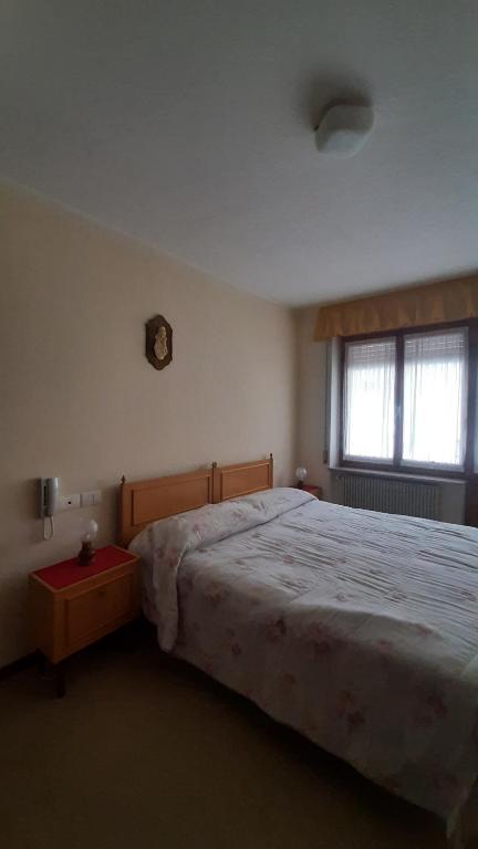 Postel nebo postele na pokoji v ubytování Albergo Bar Ristorante Da Gina
