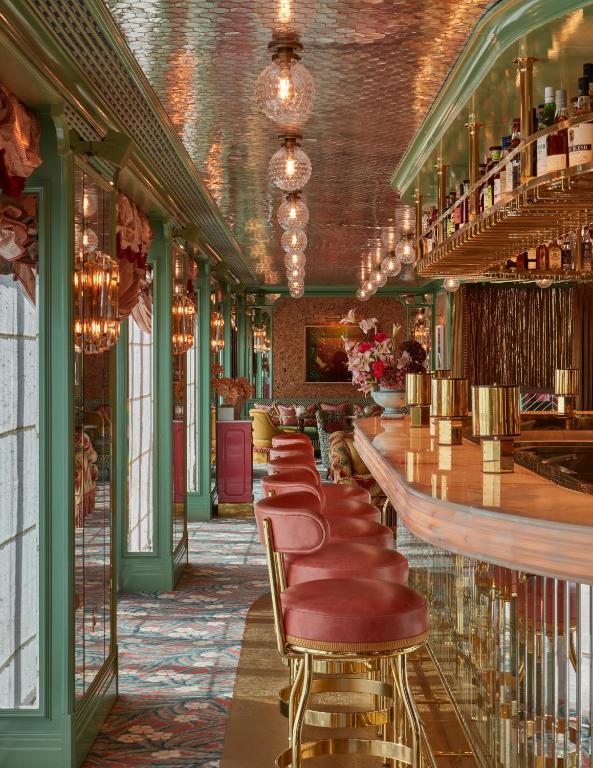 a bar with a row of bar stools at Broadwick Soho in London